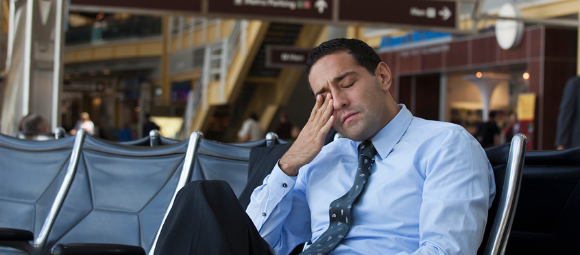 Tired Sales Engineer at Airport Terminal